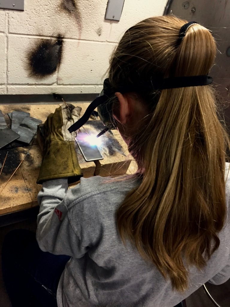 Girl practicing welding